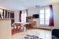 dining area with a table and four chairs in a 1-bedroom Paris luxury apartment