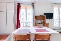 dining area with a table and four chairs in a 1-bedroom Paris luxury apartment