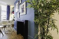 modern yet cozy design 1-bedroom Paris luxury apartmen in white, grey, and cornflower blue hues