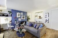 modern yet cozy design 1-bedroom Paris luxury apartmen in white, grey, and cornflower blue hues