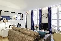 modern yet cozy design 1-bedroom Paris luxury apartmen in white, grey, and cornflower blue hues