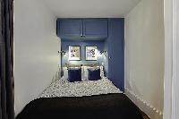 bedroom with built-in closets and a double bed in a 1-bedroom Paris luxury apartment