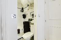 bathroom with a sink, a bathroom closet, a toilet, and a full bathtub with a detachable shower head 