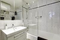 bathroom with a sink, a bathroom closet, a toilet, and a full bathtub with a detachable shower head 