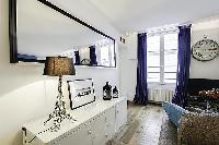 built-in cabinet, mirror, and lamp at the living area in a 1-bedroom Paris luxury apartment