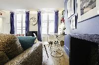 modern yet cozy design 1-bedroom Paris luxury apartmen in white, grey, and cornflower blue hues