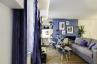 modern yet cozy design 1-bedroom Paris luxury apartmen in white, grey, and cornflower blue hues