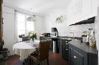 sleek and classy kitchen and dining area in a 1-bedroom Paris luxury apartment