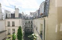 courtyard view from the French window of a a 1-bedroom Paris luxury apartment