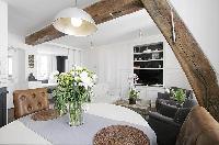 classy dining area with a table for two and exposed beam in a 1-bedroom Paris luxury apartment