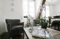 classy armchairs and center table in a 1-bedroom Paris luxury apartment