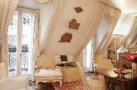 a studio luxury apartment in Paris with warm beige tones and baroque furniture