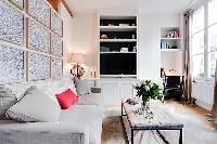 cozy living area with a small workstation in a 1-bedroom Paris luxury apartment