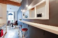 a long and sleek kitchen in a 1-bedroom Paris luxury apartment