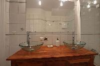 bathroom with double sinks, a bathroom cabinet, and a bathtub in a 2-bedroom Paris luxury apartment