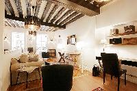 2-bedroom Paris luxury apartment with exposed antique wood beams and cream and white decor