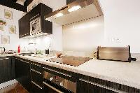 well-equipped kitchen in a 2-bedroom Paris luxury apartment