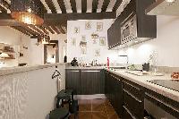 well-equipped kitchen in a 2-bedroom Paris luxury apartment