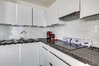 white modern kitchen in a 2-bedroom Paris luxury apartment