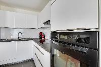 white modern kitchen in a 2-bedroom Paris luxury apartment