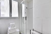 bathroom with a double sink, a bathroom cabinet, a mirror, a toilet, and a detachable shower head in