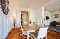 chic dining set for six with accessto the living area and kitchen in a 2-bedroom paris luxury apartm