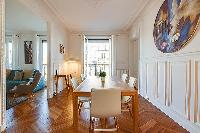 chic dining set for six with accessto the living area in a 2-bedroom paris luxury apartment