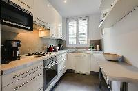 A compact kitchen in a 2-bedroom paris luxury apartment