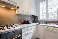 A compact kitchen in a 2-bedroom paris luxury apartment