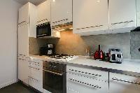 A compact kitchen in a 2-bedroom paris luxury apartment