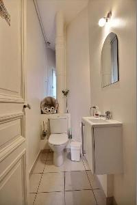 toilet in the water closet beside the kitchen in a 2-bedroom Paris luxury apartment