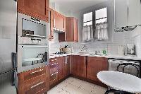 toilet in the water closet beside the kitchen in a 2-bedroom Paris luxury apartment