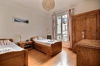 second bedroom is equipped with two single beds, a wardrobe, and a chest of drawers in a 2-bedroom P