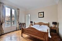 first bedroom with an en-suite bathroom furnished with double sinks, a bathroom cabinet, mirrors, an