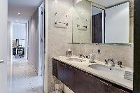 bathroom equipped with double sinks, a toilet, and a shower area in a 4-bedroom paris luxury apartme