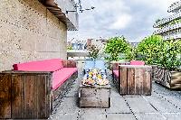 terrace with pieces of patio furniture in a 4-bedroom paris luxury apartment