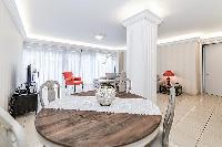 round wooden dining table in a 4-bedroom paris luxury apartment