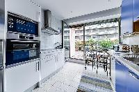 spacious blue and white kitchen situated near the terrace