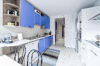 spacious blue and white kitchen situated near the terrace