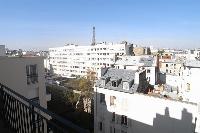 balcony with views of the Parisian cityscape and the Eiffel Tower in a 2-bedroom Paris luxury apartm