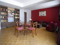 a 2-bedroom Paris luxury apartment with traditional interiors mostly wooden space with red accents