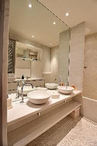modern bathroom with two sinks and shower in a Paris luxury apartment
