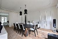 elegant 8-seater dining area in black and white hues in Paris luxury apartment
