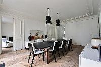 elegant 8-seater dining area in black and white hues in Paris luxury apartment