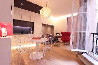 chic dining area, kitchen, and living area  in a 2-bedroom Paris luxury apartment
