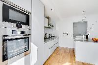 modern and immaculate white kitchen in a 2-bedroom paris luxury apartment