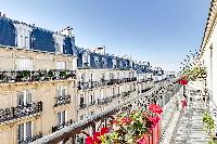 a stylish balcony with wonderful views of the Parisian building in a 2-bedroom paris luxury apartmen