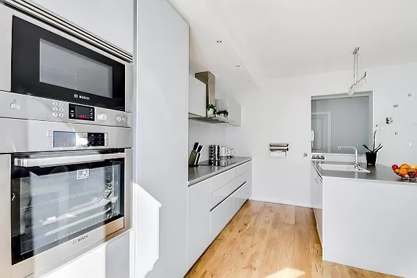 modern and immaculate white kitchen in a 2-bedroom paris luxury apartment