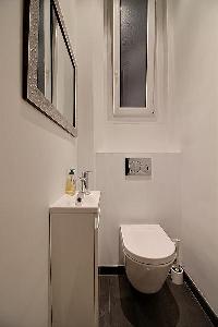 a water closet with a toilet and a sink in a 3-bedroom Paris luxury apartment