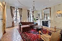 elegant living area with ornate and high ceilings in its neutral motif of a Paris luxury apartment